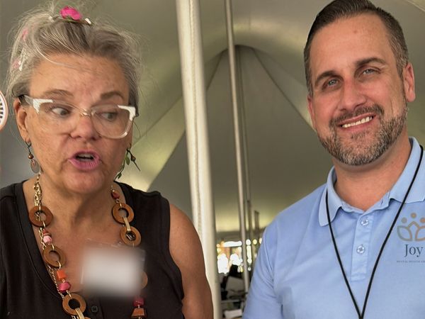 Dr. Adam Joy and a Joy Mental Health Group team member smiling at the outreach booth at ViewFest at the Detroit Zoo